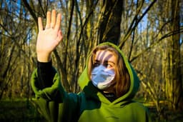 woman in green hoodie holding clear glass ball — Photo Maria Lysenko / Unsplash