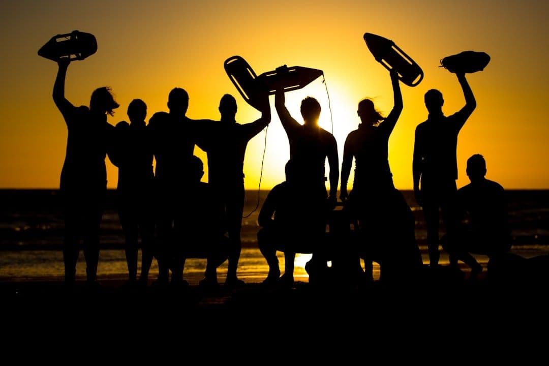 a group of people standing next to each other on a beach — Photo Dirk Erasmus / Unsplash
