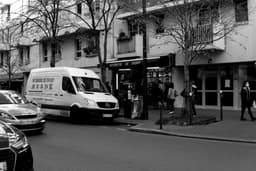 grayscale photo of white van on road — Photo Vlad B / Unsplash