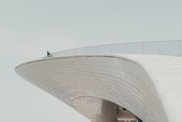 people walking on white concrete building during daytime — Photo Michiel Annaert / Unsplash