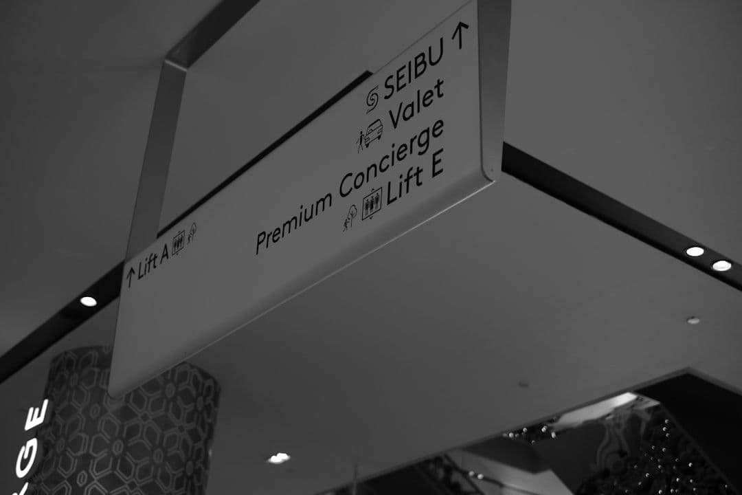 a black and white photo of a street sign — Photo Gilbert Ng / Unsplash