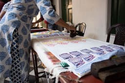 woman putting stamps on white towel on table — Photo Rahul Jain / Unsplash
