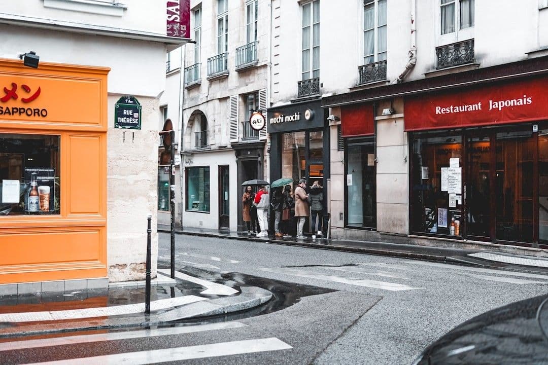 people walking on sidewalk near building during daytime — Photo Vlad B / Unsplash