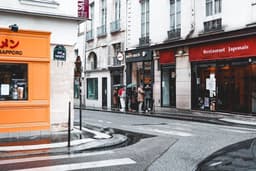 people walking on sidewalk near building during daytime — Photo Vlad B / Unsplash