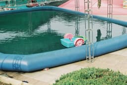 an inflatable swimming pool with a toy in it — Photo Bournes senruoB / Unsplash