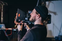 man holding video camera — Photo Levi Stute / Unsplash