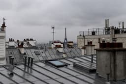 a view of the roofs of a building in paris — Photo Fabien Maurin / Unsplash