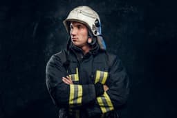 a man in a fireman's uniform with his arms crossed — Photo Look Studio / Unsplash