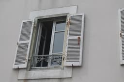 two windows with shutters open on a building — Photo Elinor Longley / Unsplash
