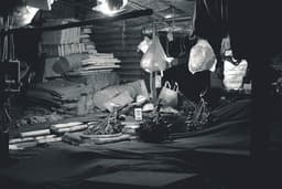 A black and white photo of a room filled with items — Photo Nguyễn Hiệp / Unsplash