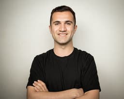 Millennial Guy Laughing Looking At Camera Standing — Photo Mostafa KordZangeneh / Unsplash