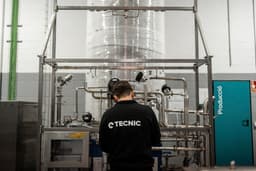 Engineer inspecting a stainless steel buffer system in an industrial production facility. — Photo TECNIC Bioprocess Solutions / Unsplash
