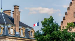This photo was taken in the square outside Strasbourg Cathedral, and shows a French flag, not quite at full height. — Photo Ed Wingate / Unsplash