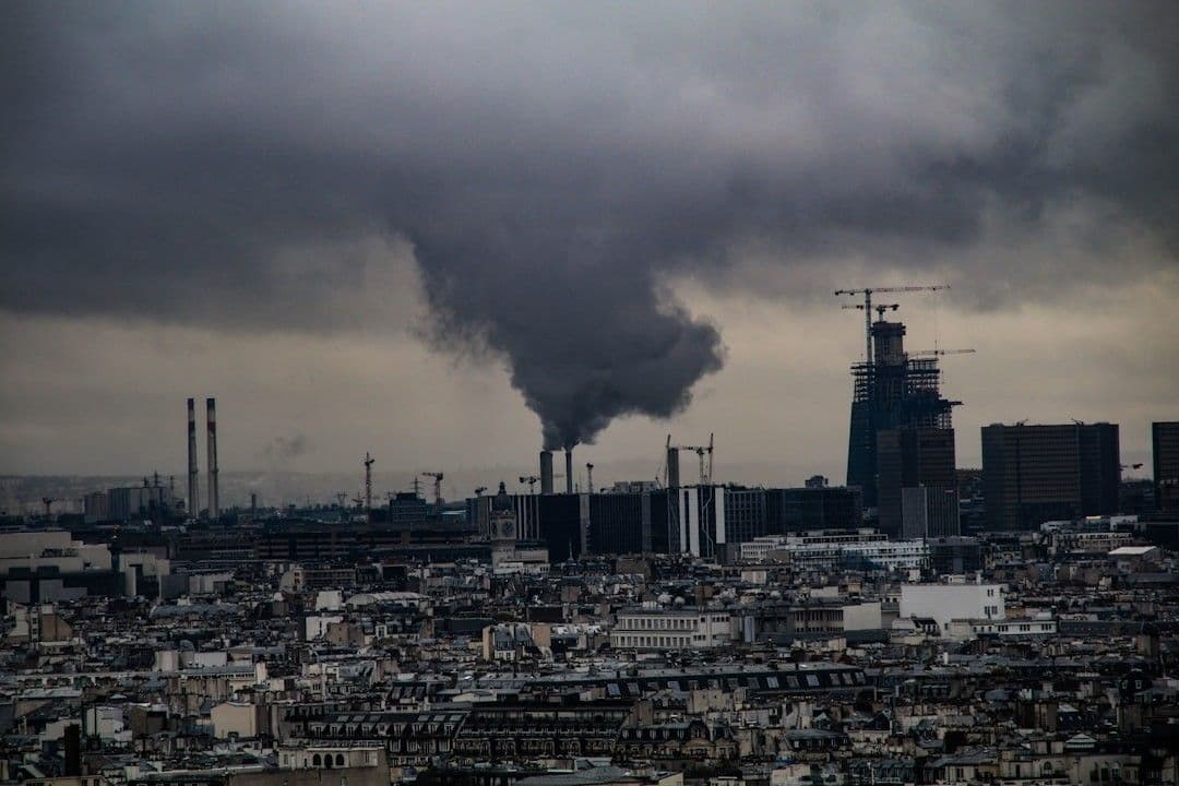 a city with smokestacks and smokestacks — Photo Ioana / Unsplash
