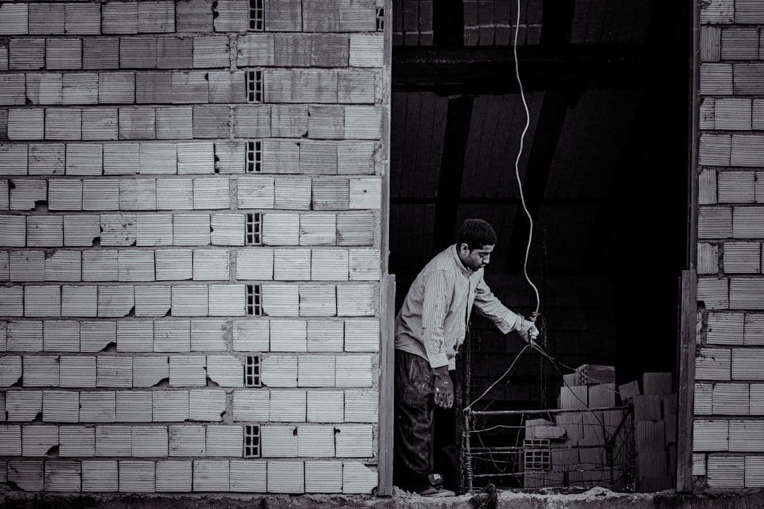man in white dress shirt and pants holding a stick — Photo Alireza Zarafshani / Unsplash