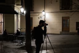 a man standing on a street holding a camera — Photo Javier Gómez / Unsplash