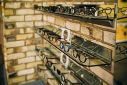 a display of glasses on a brick wall — Photo EYES on St Albans / Unsplash