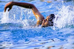 man swimming in body of water — Photo TALAVIYA RAHUL / Unsplash