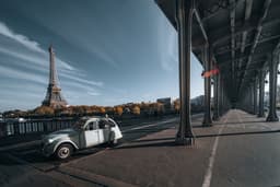 an old car parked on the side of the road — Photo Masood Aslami / Unsplash