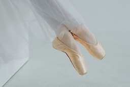 a ballerina's feet in a ballet shoe — Photo Anita Austvika / Unsplash