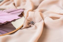 a close up of a mirror on a cloth — Photo Amina Atar / Unsplash