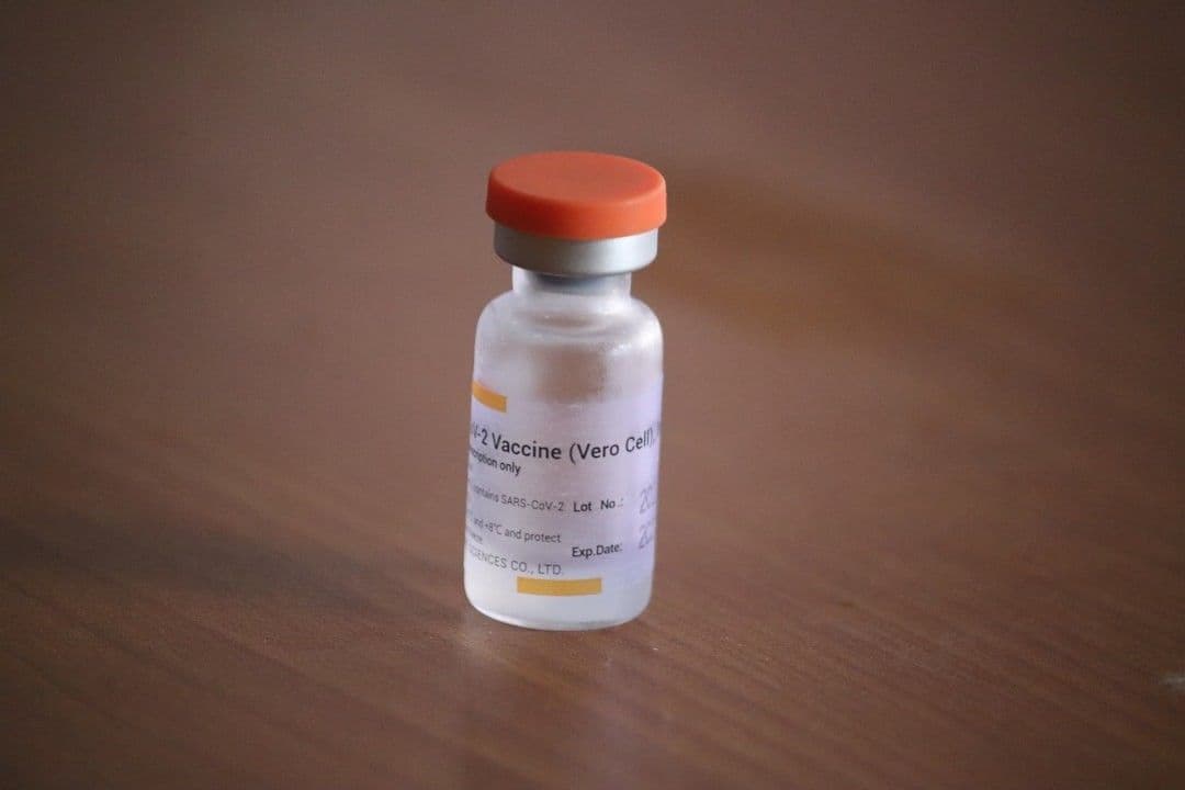 background of sinovac covid-19 vaccination bottle — Photo Mufid Majnun / Unsplash