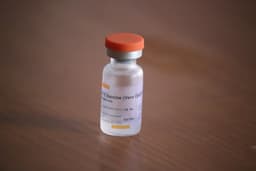 background of sinovac covid-19 vaccination bottle — Photo Mufid Majnun / Unsplash