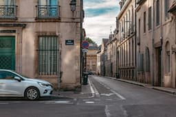 a car parked on the side of a street — Photo Zhu Yunxiao / Unsplash