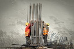 two men working on a construction site — Photo Yk K / Unsplash