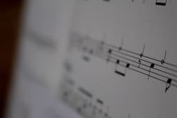 white musical notes on white paper — Photo William Parsons / Unsplash
