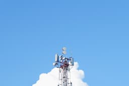 A cell phone tower with a blue sky in the background — Photo Oleg Laptev / Unsplash