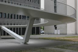 a white building with a curved staircase — Photo Danny De Vylder / Unsplash
