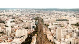 An aerial view of a city with lots of tall buildings — Photo Alin Gavriliuc / Unsplash