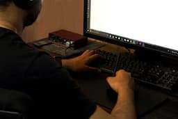 A man using computer working on his project — Photo Usman Yousaf / Unsplash