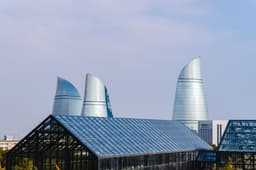 Flame towers in baku are visible in the sky. — Photo Zulfugar Karimov / Unsplash