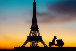 a scooter is parked in front of the eiffel tower — Photo Happysurd Photography / Unsplash