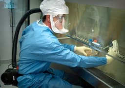 Created in 2005, this photograph depicts one of the Centers for Disease Control's (CDC) staff microbiologists using an electronic pipetter to extract reconstructed 1918 Pandemic Influenza virus from a vial containing a supernatant culture medium. — Photo CDC / Unsplash