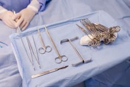 A hospital bed with surgical equipment on top of it — Photo Jonathan Borba / Unsplash