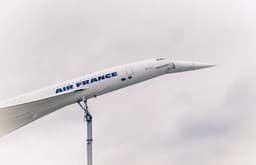 a large air france jet flying through a cloudy sky — Photo Sindy Süßengut / Unsplash