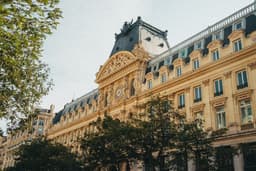 a large building with a clock on the top of it — Photo Mat / Unsplash