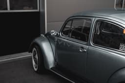 a grey car parked in front of a building — Photo iwin / Unsplash