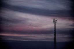 A radio tower reaches towards a moody sunset. — Photo Joaquín Cuesta Fuentes / Unsplash