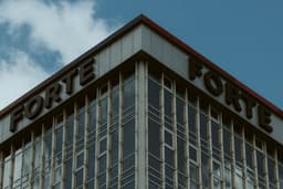 a tall building with a sign on top of it — Photo Stanislav Vdovin / Unsplash