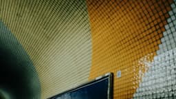 A colorful mosaic tunnel wall is shown. — Photo Cande Westh / Unsplash