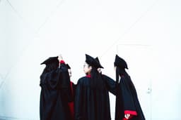 people in academic dress standing — Photo Stephanie Hau / Unsplash