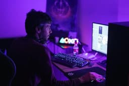 a man sitting in front of a computer monitor — Photo Amine mouzaoui / Unsplash