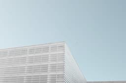 grey concrete building under clear blue sky — Photo Jorge Mallo / Unsplash