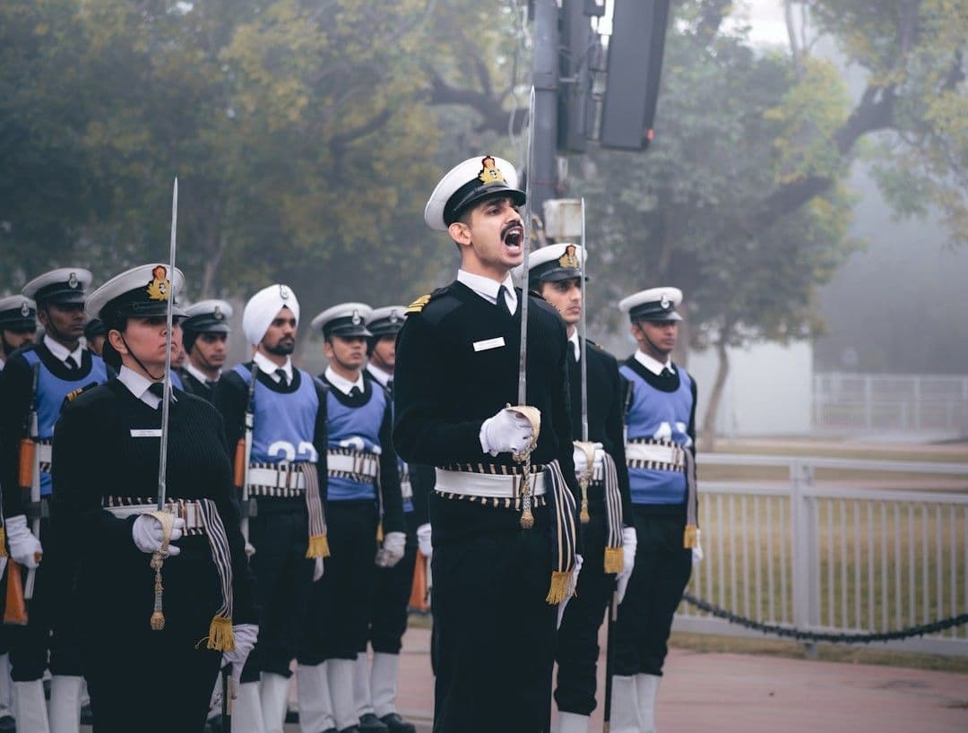 A group of men in uniform standing next to each other — Photo Pramod Tiwari / Unsplash