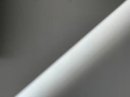 a close up of a white wall with a light shining on it — Photo Bernd 📷 Dittrich / Unsplash
