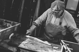 Old fisherman cutting fish. — Photo Jez Timms / Unsplash